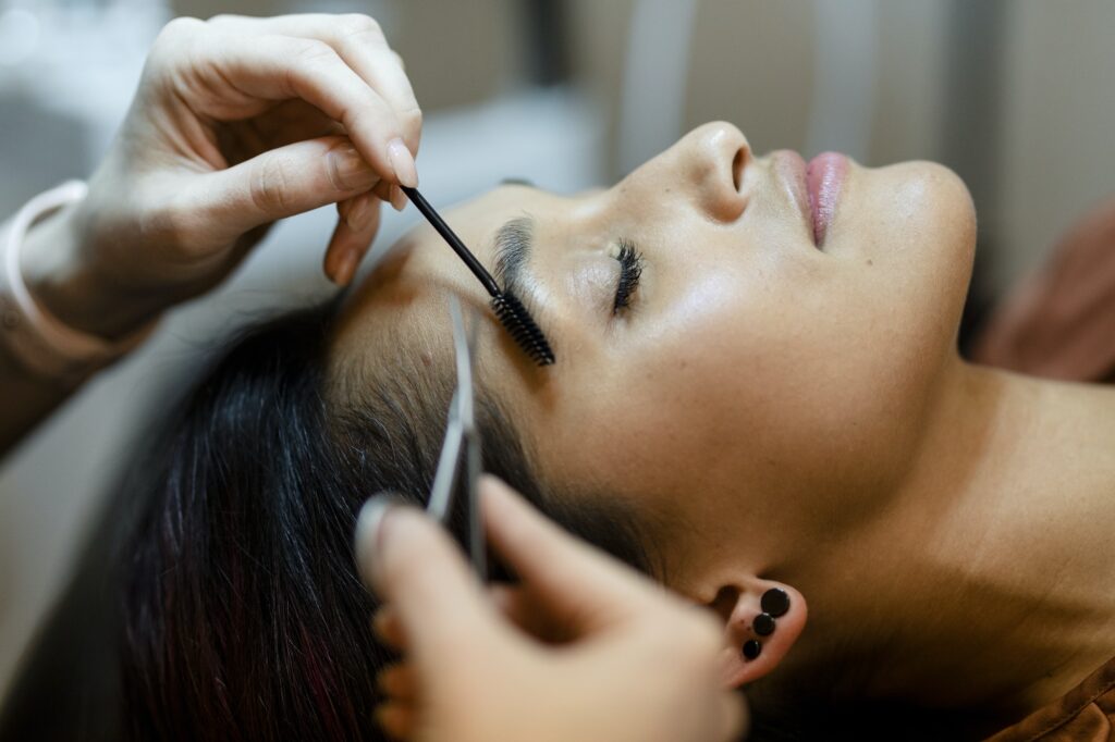 Customer getting eyebrow treatment at a beauty salon